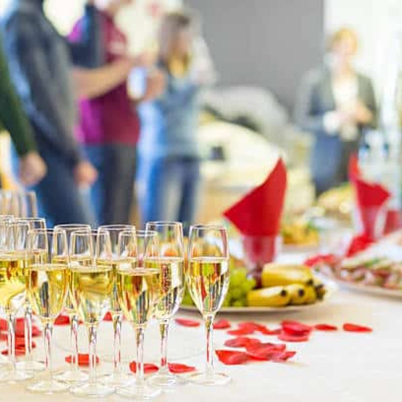 Banquet event. Table with the wineglasses, snacks and cocktails.